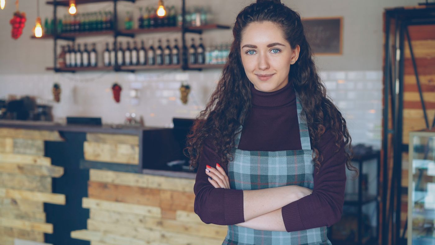 Bar owner standing with arms crossed
