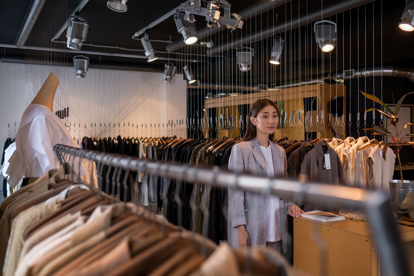 Boutique owner arranging her clothing racks